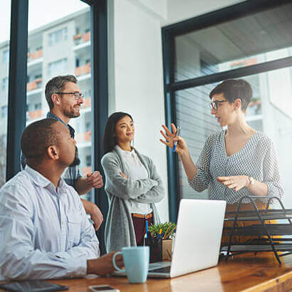 Business team discussing ideas around a table in an office